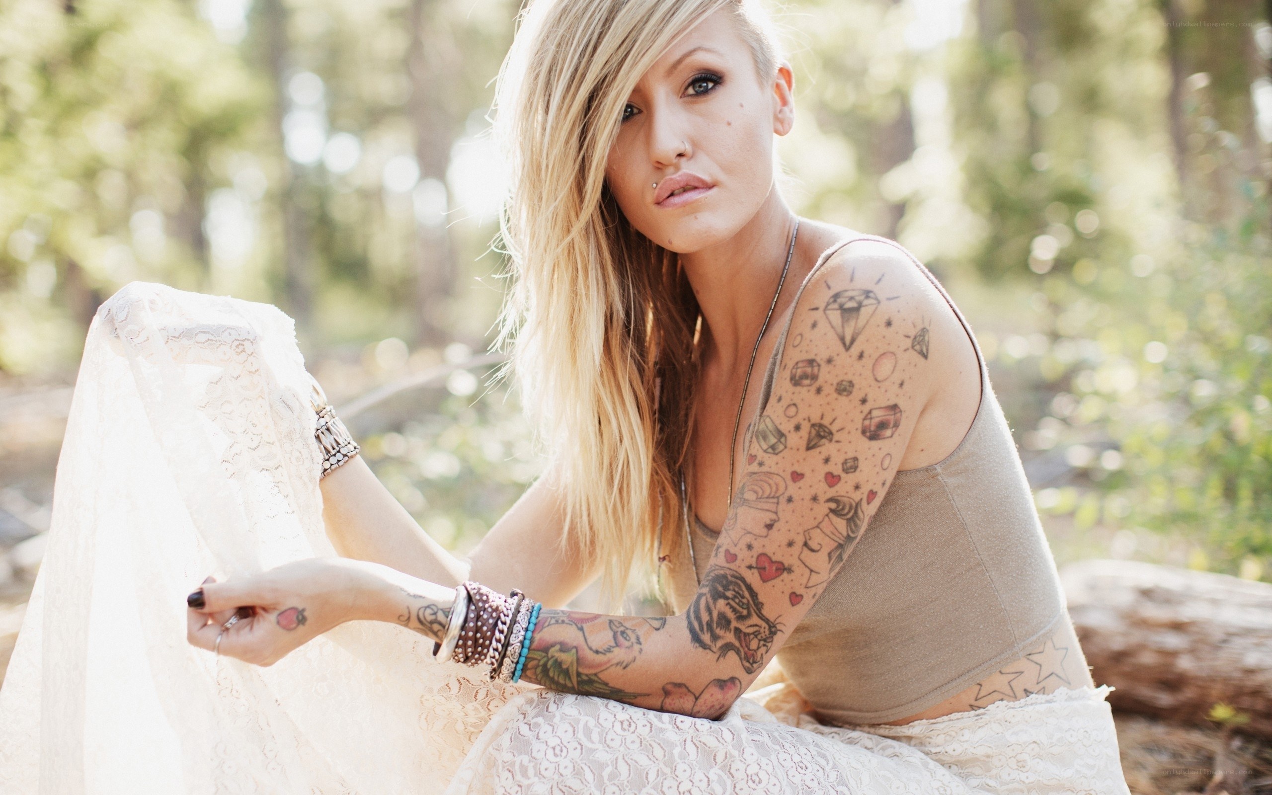 woman with tattoos in forest