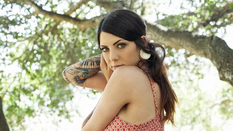 woman with tattoos in garden