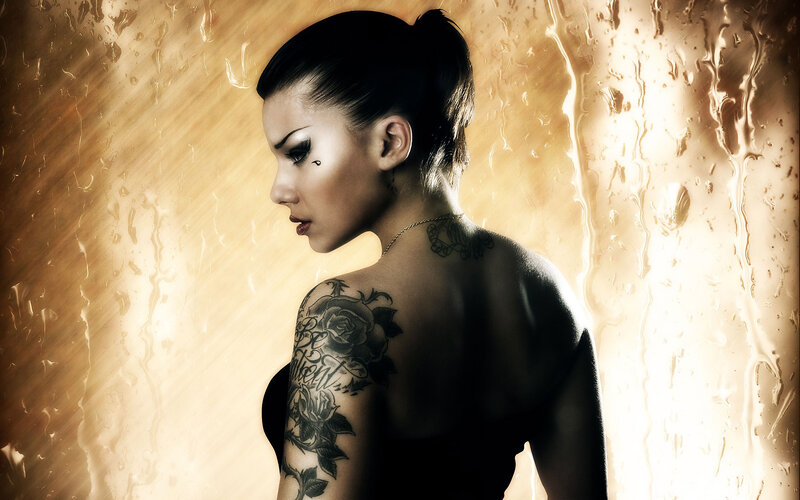 woman with tattoos in golden light