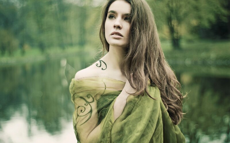 woman with tattoos in green