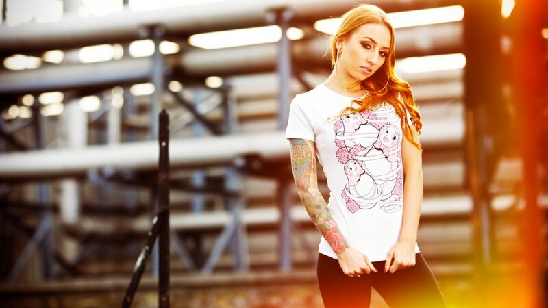 woman with tattoos in industrial setting