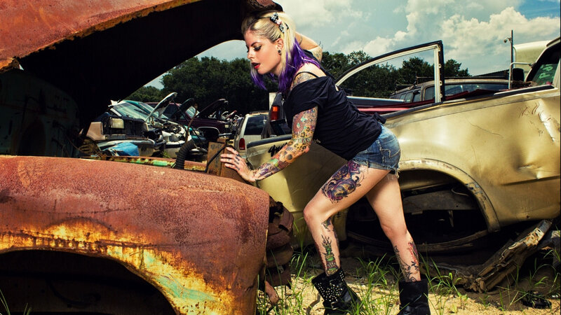 Woman with Tattoos in Junkyard