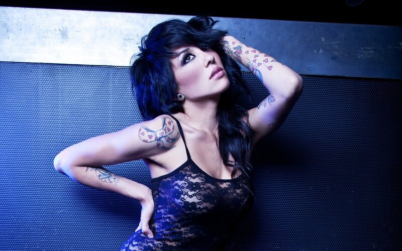 woman with tattoos in lace dress