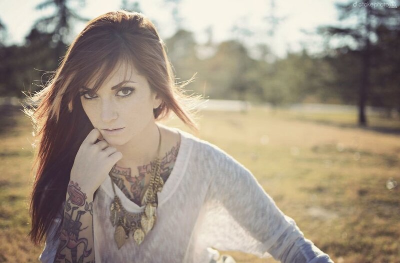 woman with tattoos in park