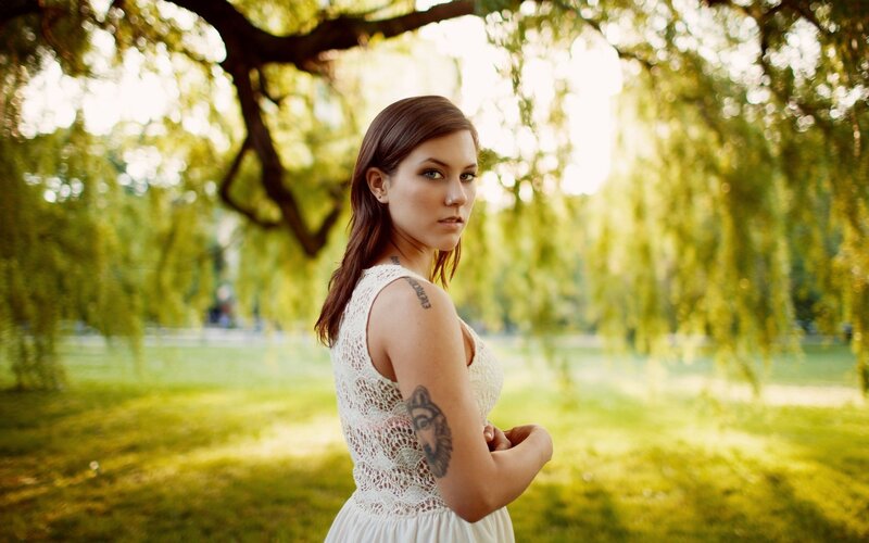 woman with tattoos in park