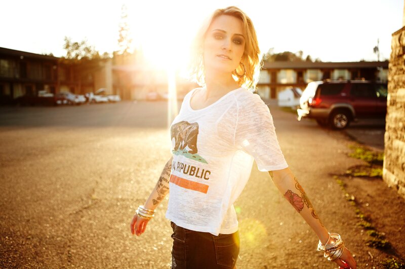 woman with tattoos in parking lot