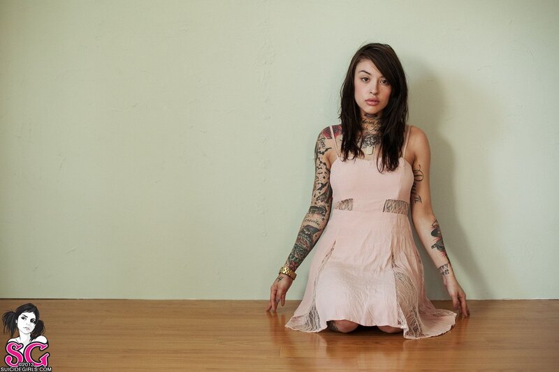 woman with tattoos in pink dress