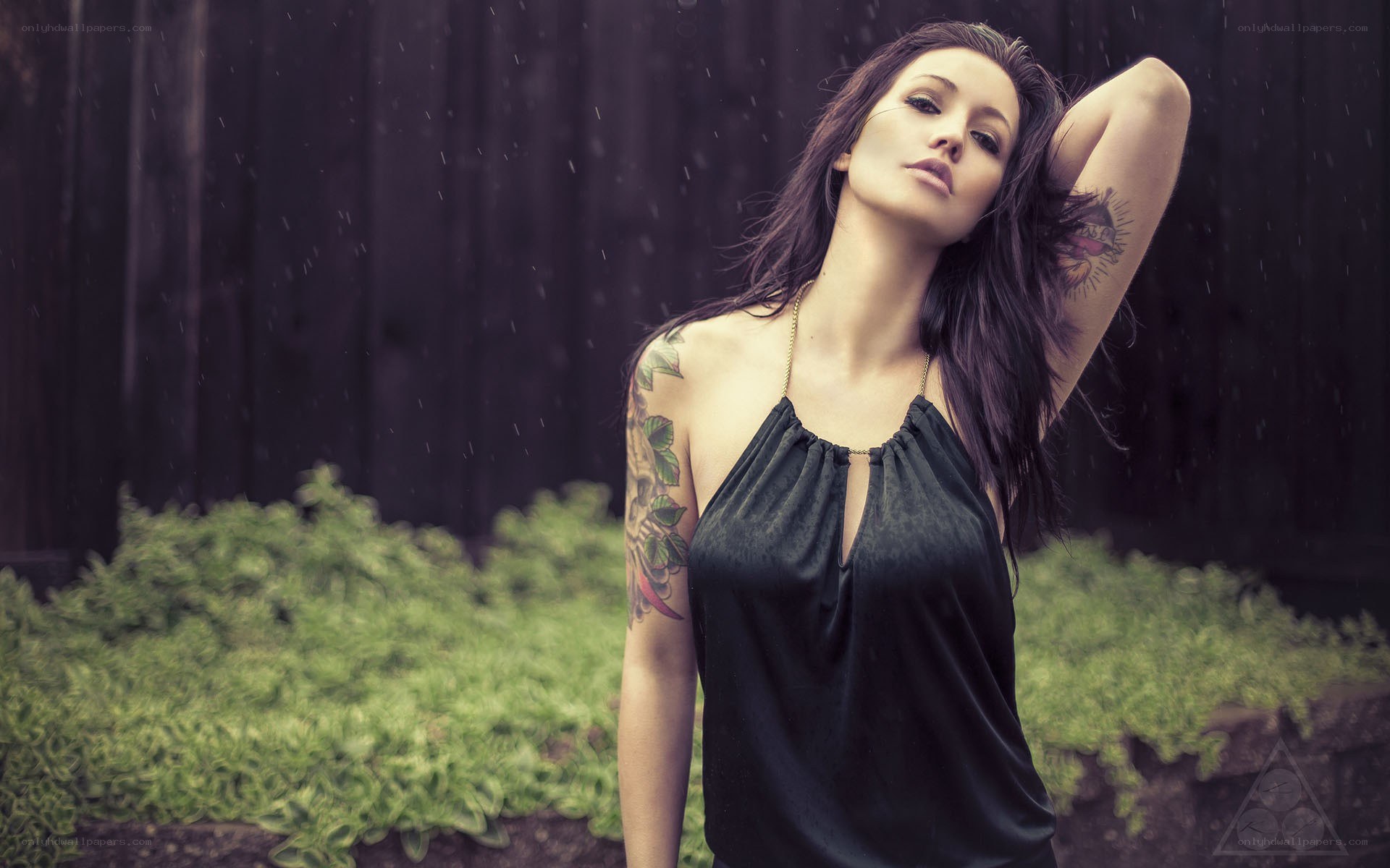 woman with tattoos in rain