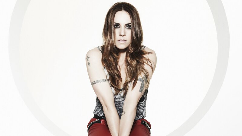 woman with tattoos in red pants