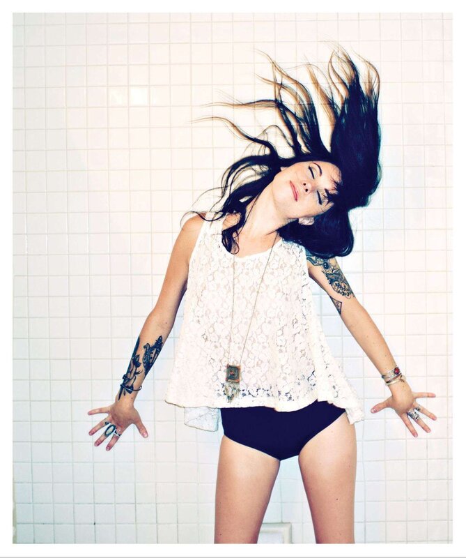 woman with tattoos in shower