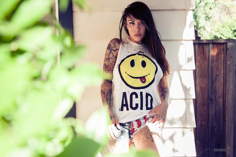 woman with tattoos in smiley shirt