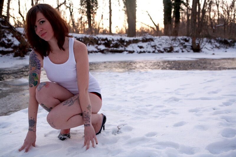 woman with tattoos in snow