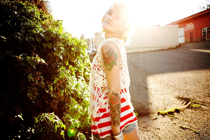 woman with tattoos in sunlight