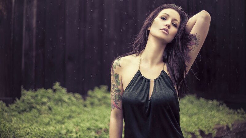 woman with tattoos in the rain