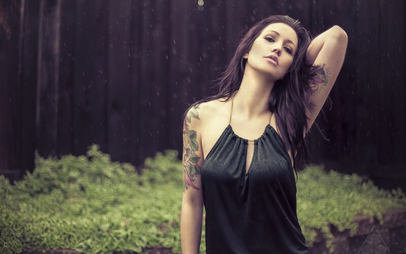 woman with tattoos in the rain