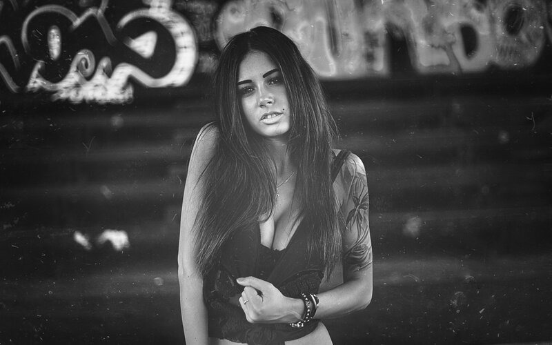 woman with tattoos in urban setting