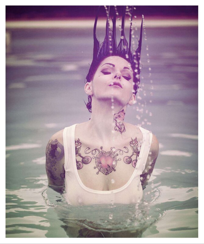 woman with tattoos in water