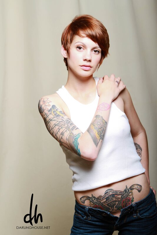 woman with tattoos in white tank top