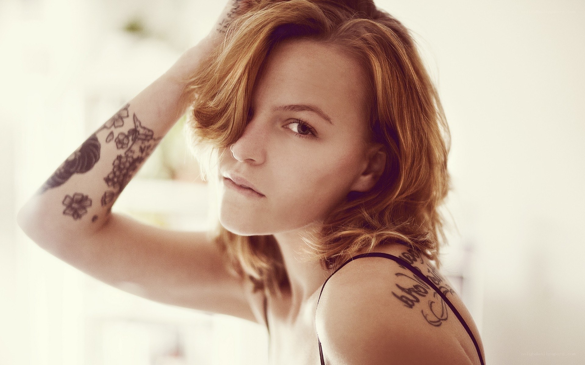 woman with tattoos looking at camera