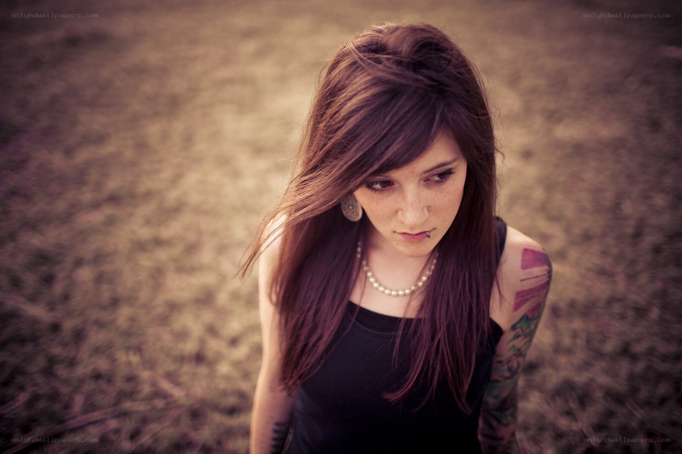 woman with tattoos looking down