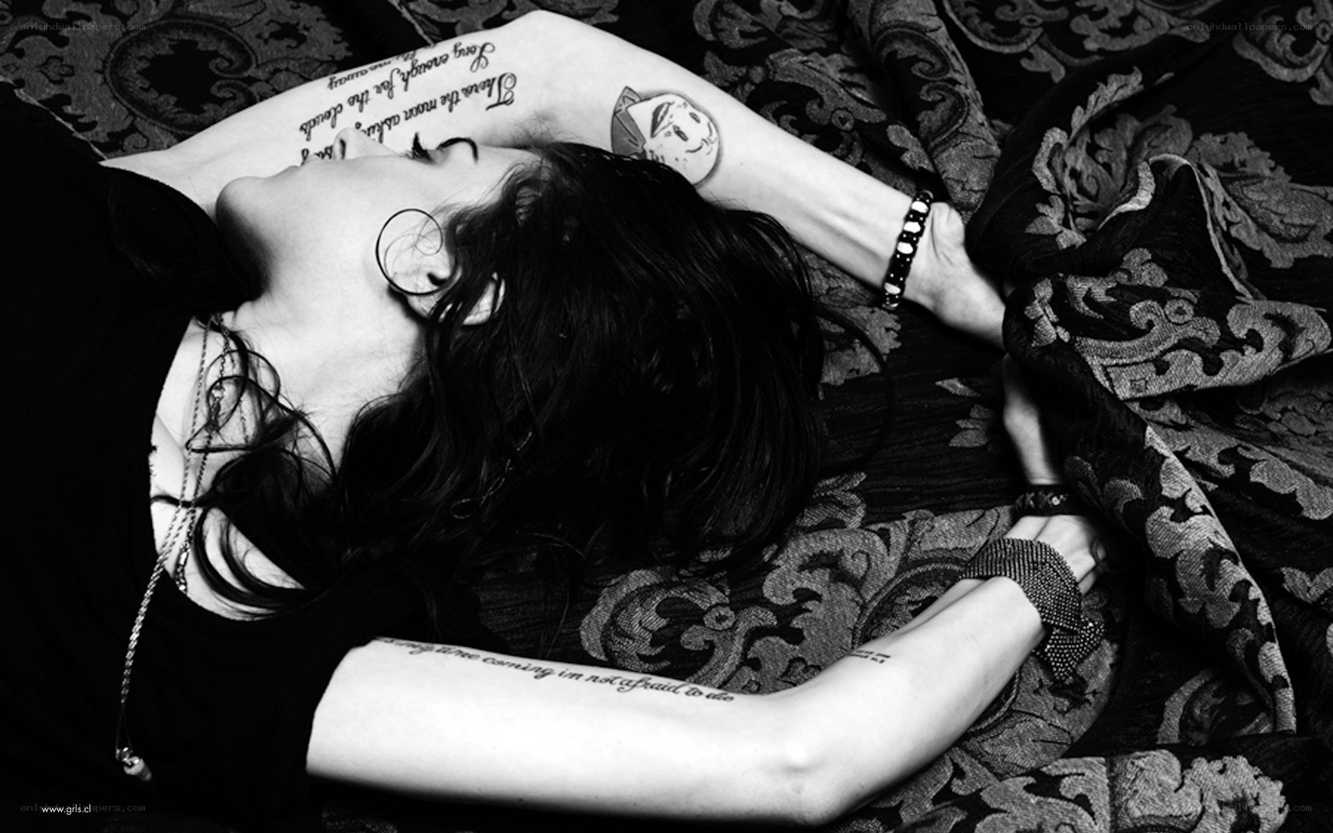 woman with tattoos lying down