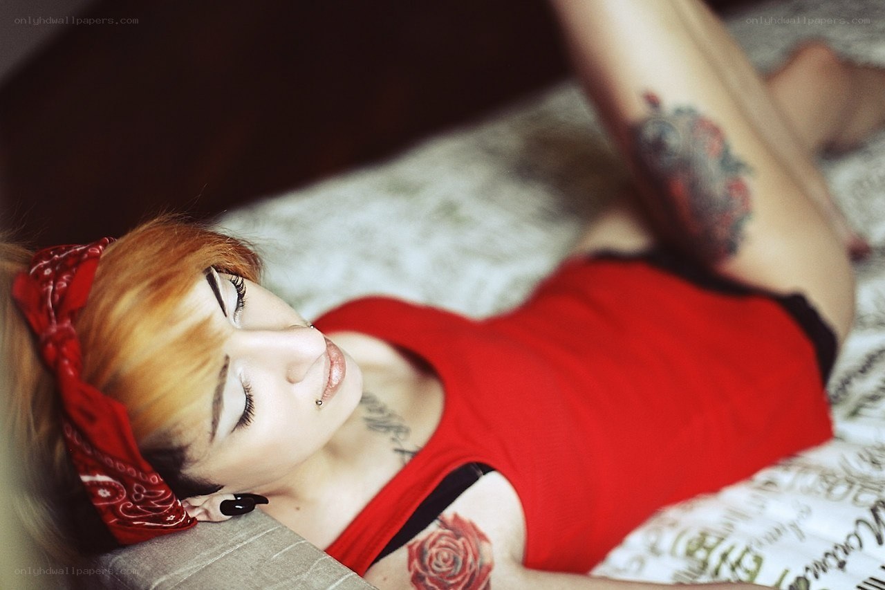 woman with tattoos lying down