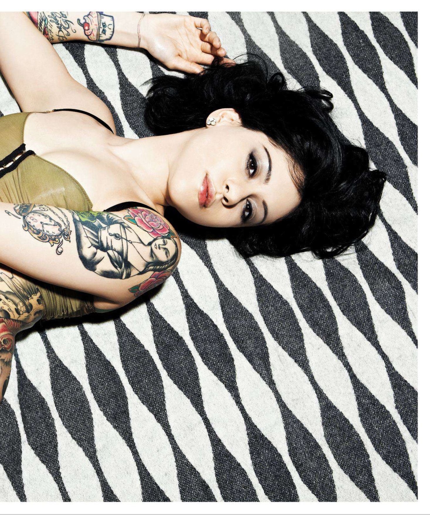 woman with tattoos lying down