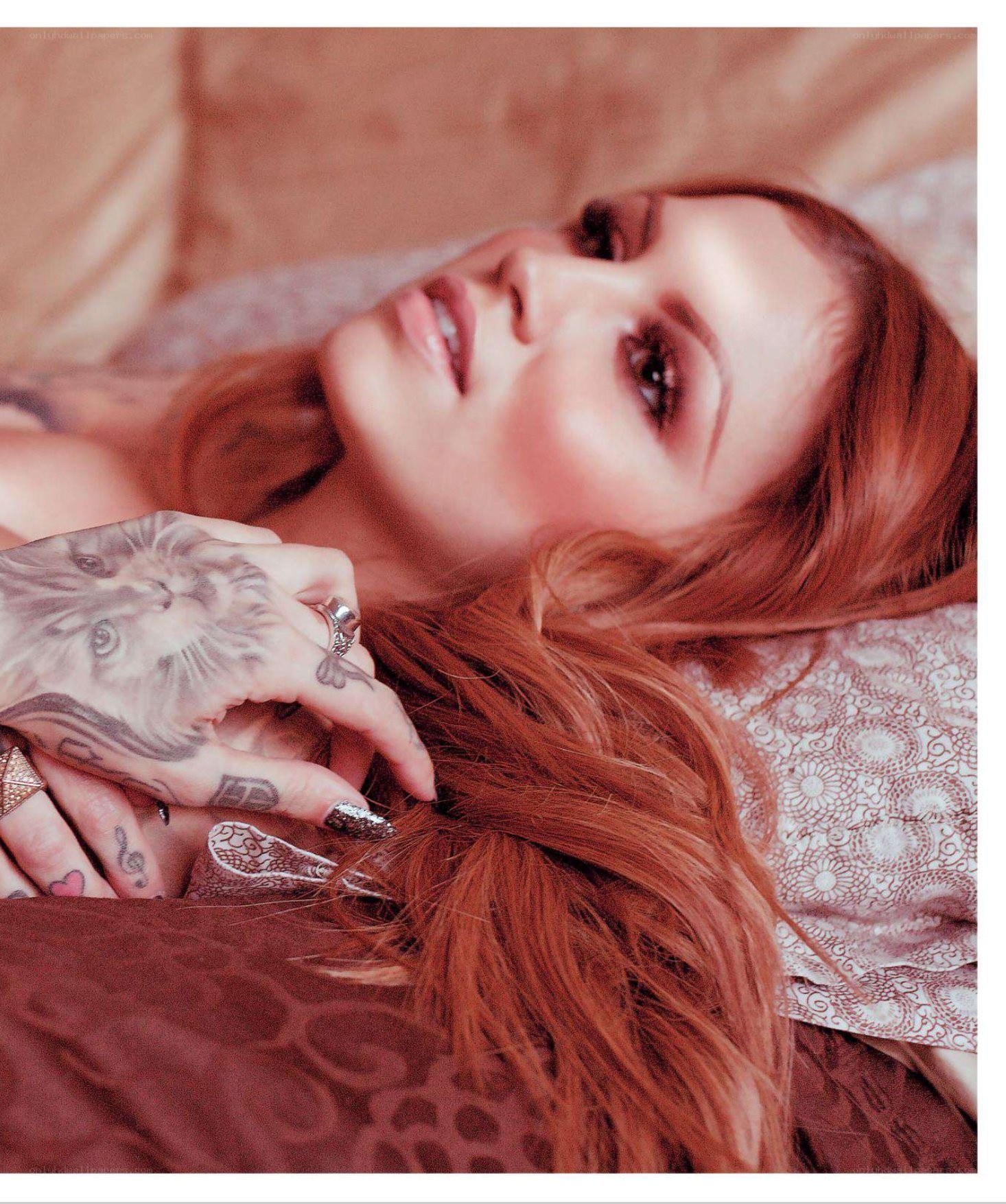 woman with tattoos lying down