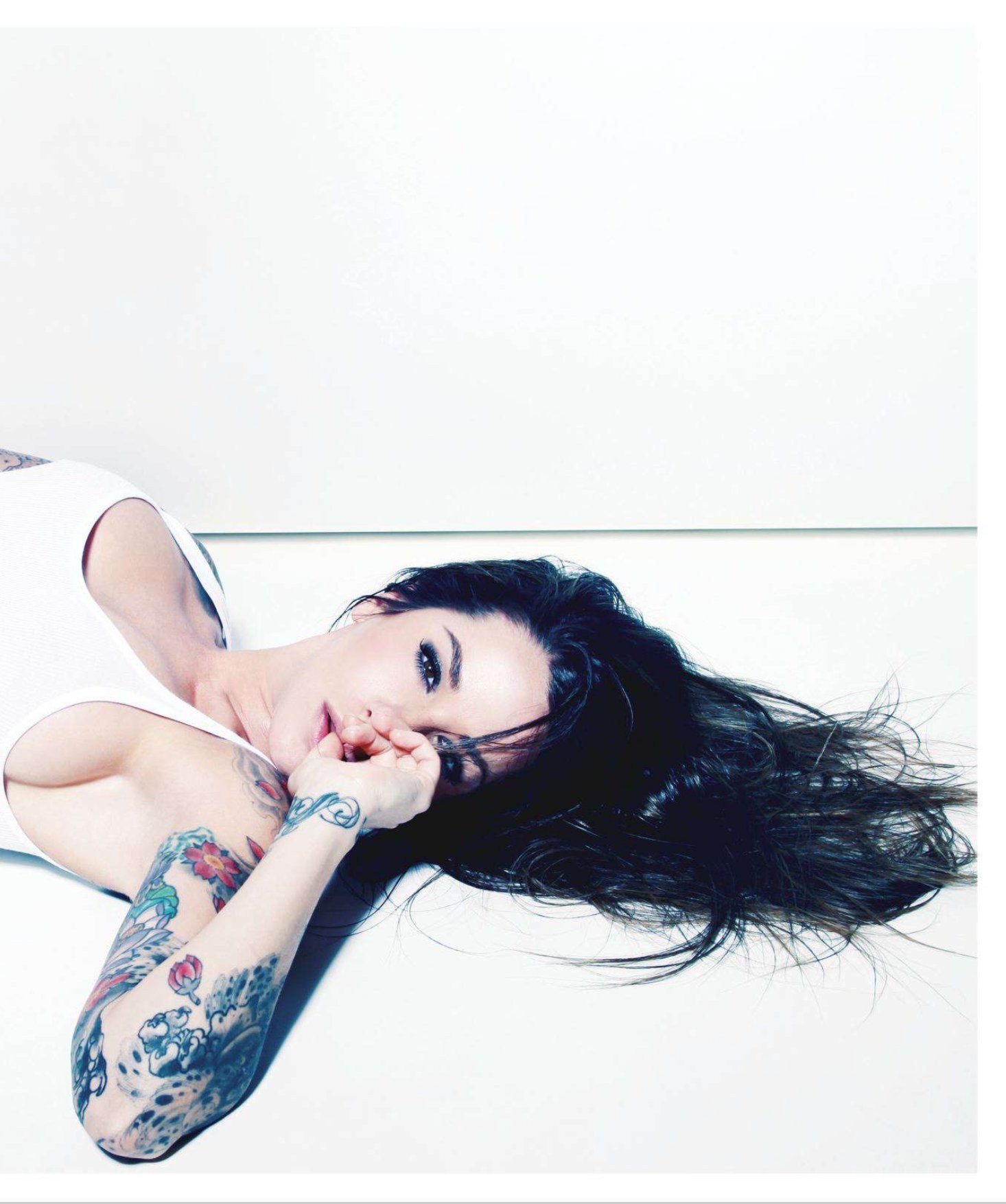 woman with tattoos lying down