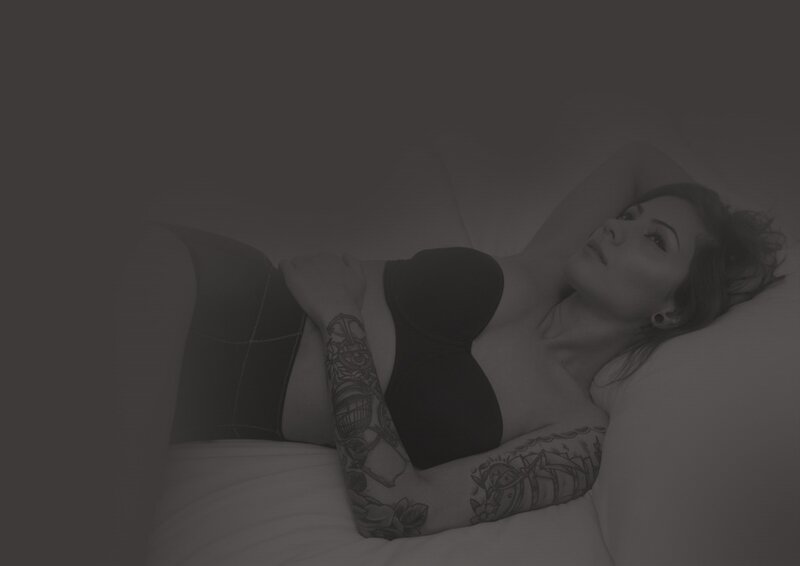 woman with tattoos lying down