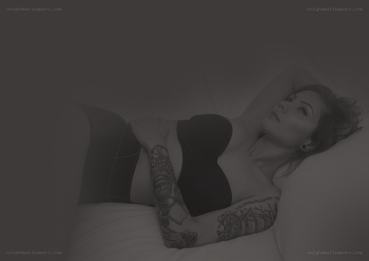 woman with tattoos lying down
