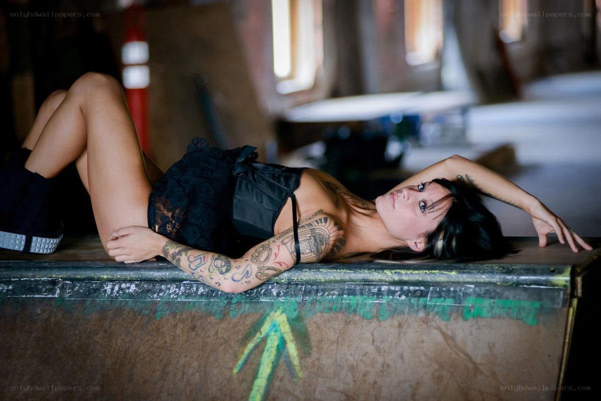 woman with tattoos lying down