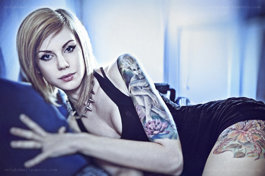 woman with tattoos lying down