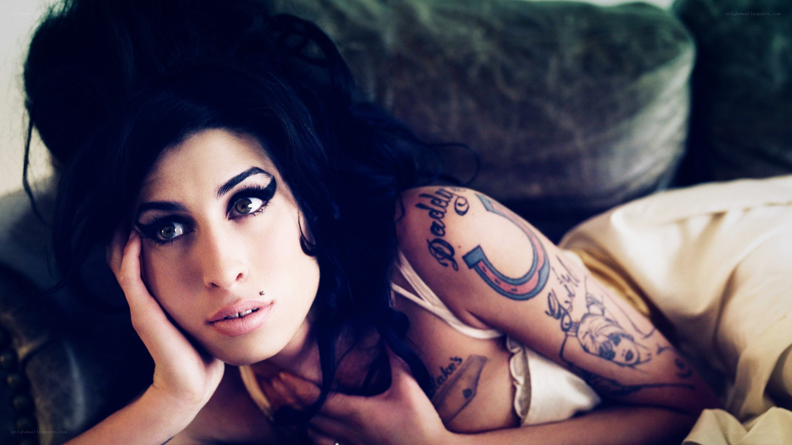 woman with tattoos lying down