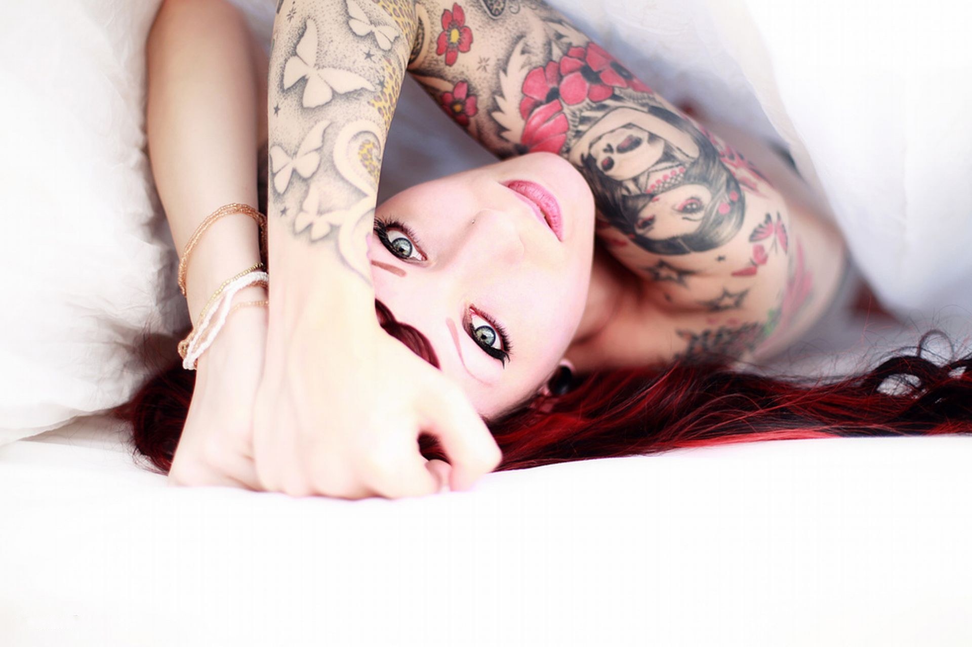 woman with tattoos lying down