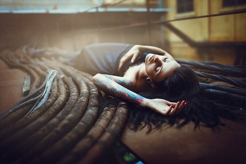 woman with tattoos lying on cables