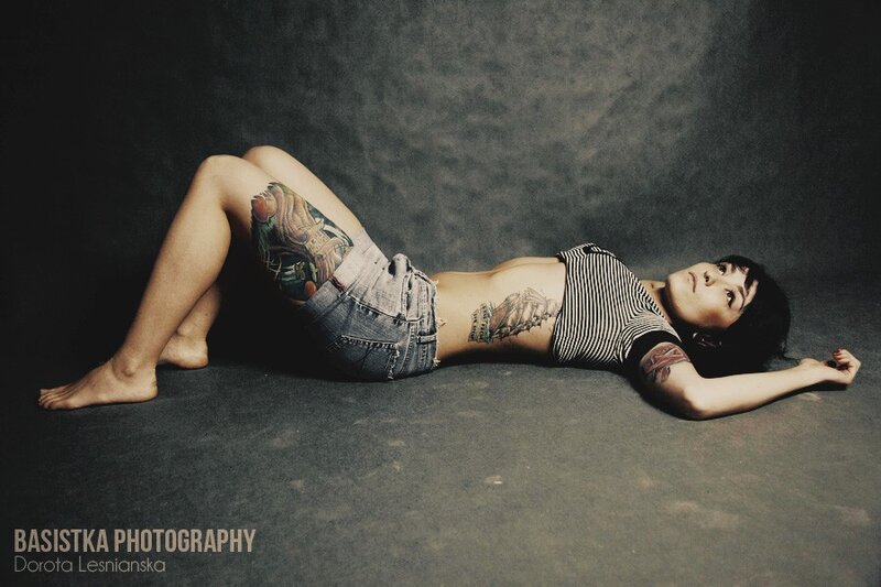 woman with tattoos lying on floor