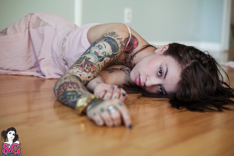 woman with tattoos lying on floor