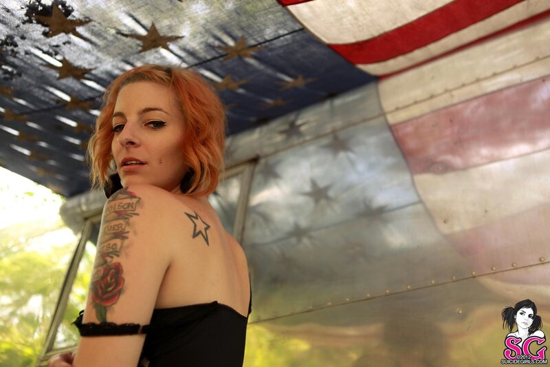 woman with tattoos near flag