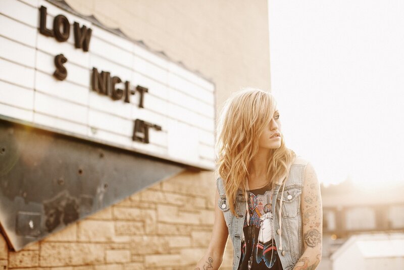 woman with tattoos near theater