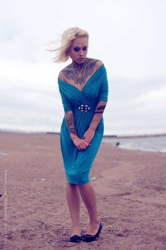 woman with tattoos on beach