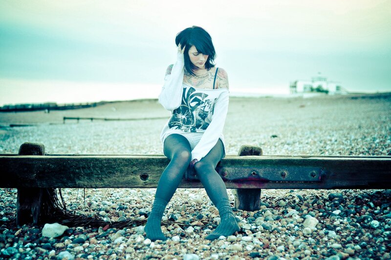 Woman with tattoos on beach