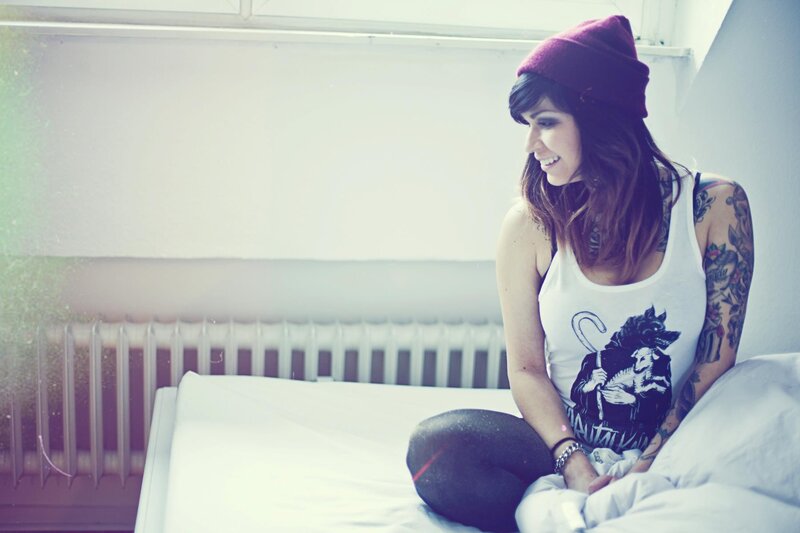 woman with tattoos on bed