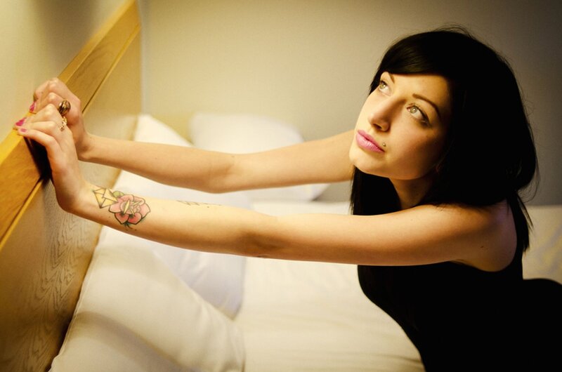 woman with tattoos on bed