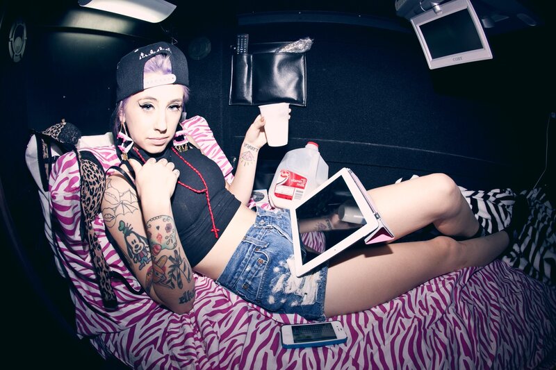 woman with tattoos on bed