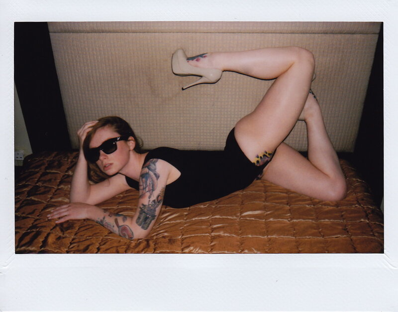 woman with tattoos on bed