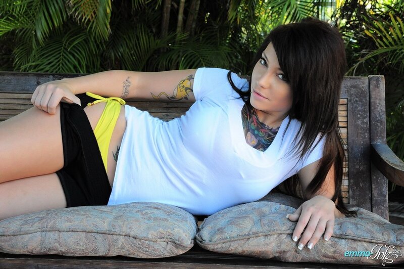woman with tattoos on bench