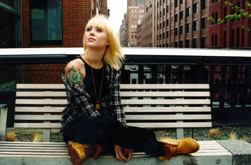 Woman with tattoos on bench