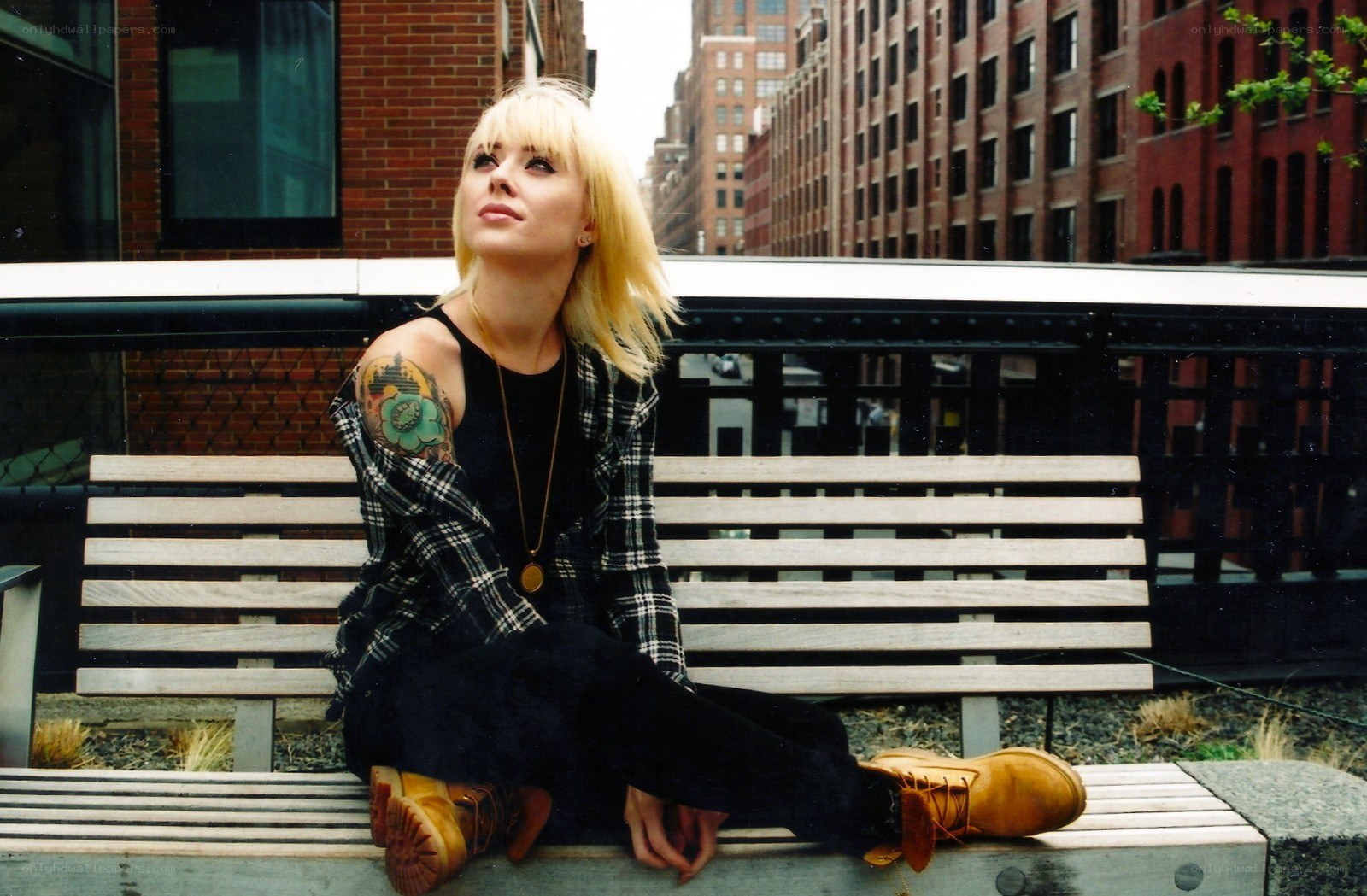 Woman with tattoos on bench