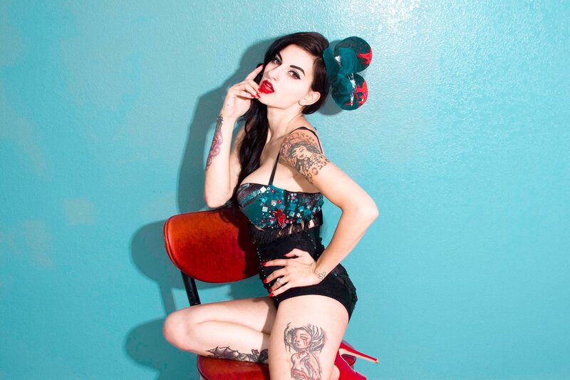 woman with tattoos on chair